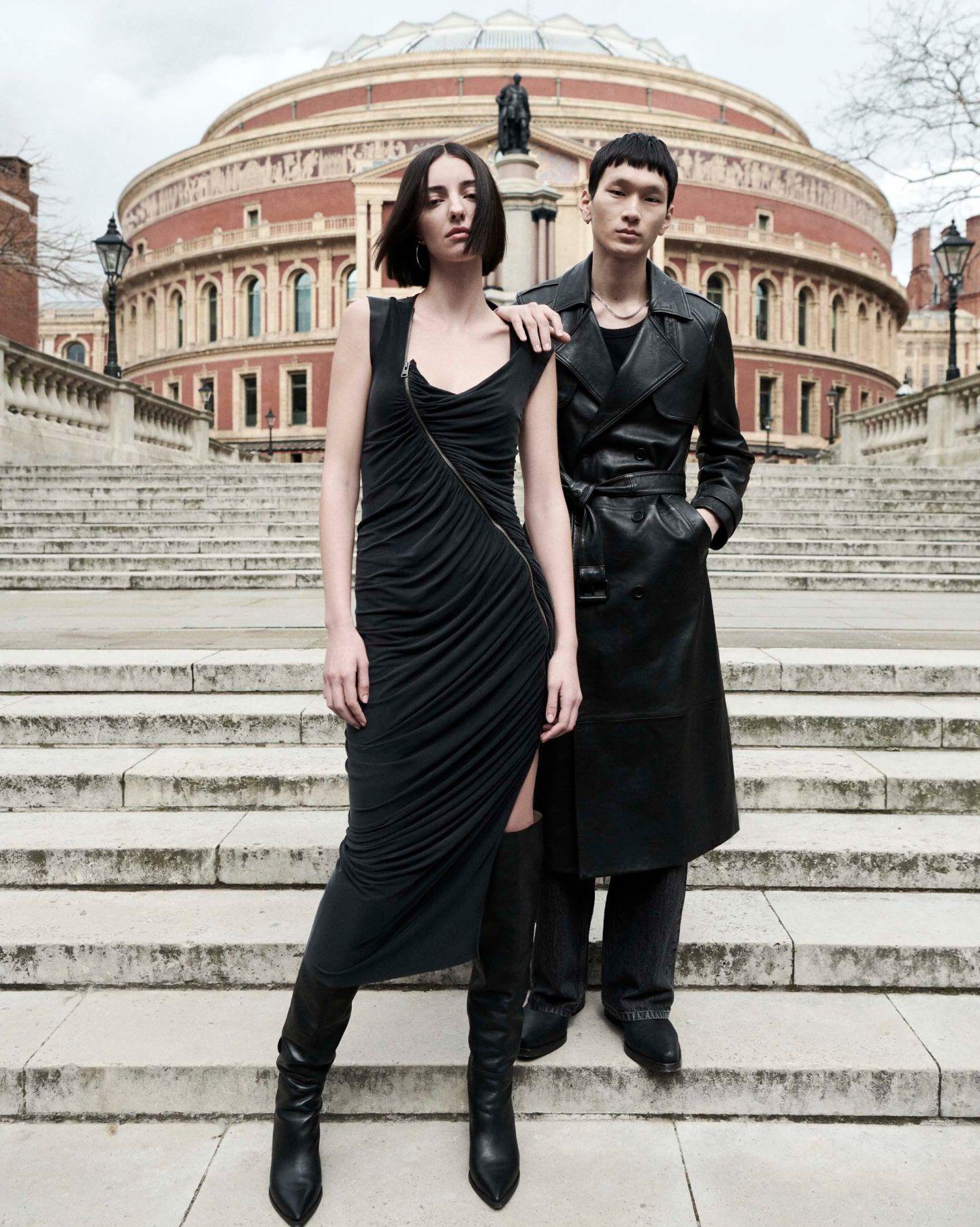 AllSaints campaign portrait of two models in black leather and tailoring on the steps of the Royal Albert Hall